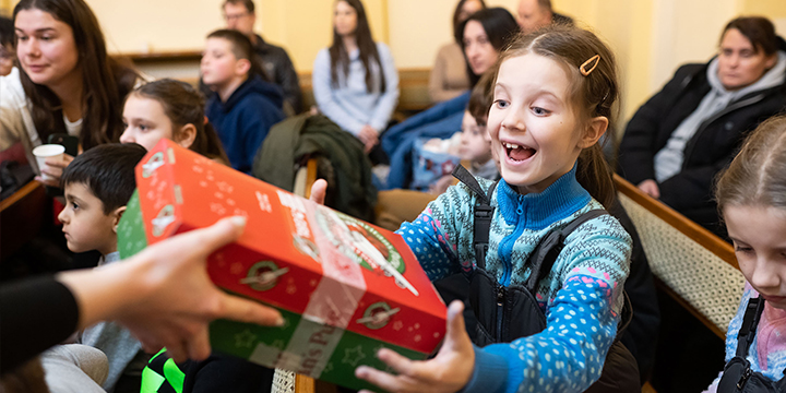 girl receiving preprinted shoebox