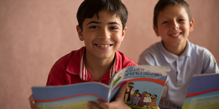 Boy reading The Greatest Journey book