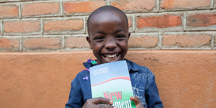 Boy holding Bible after graduating