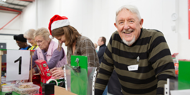 Group of volunteers processing shoebox gifts