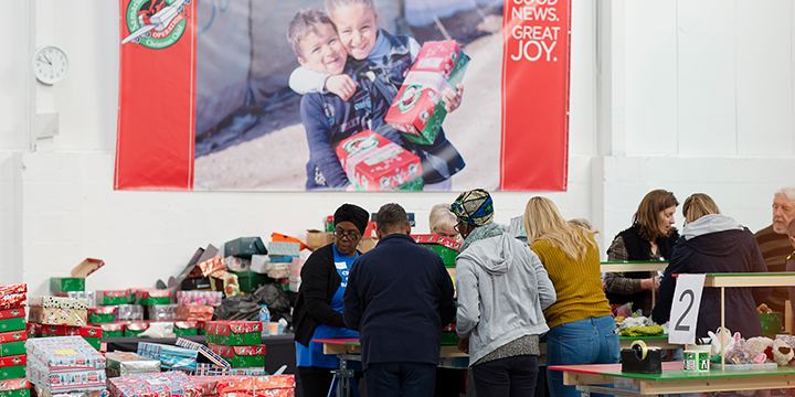 Group of volunteers processing shoebox gifts