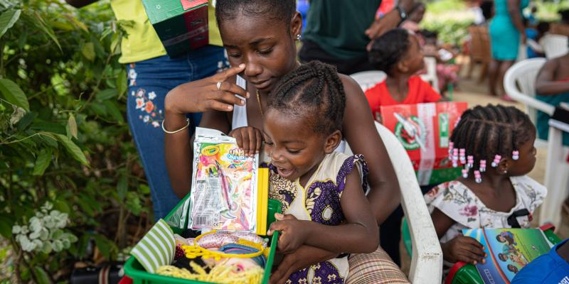 Girl excited to see the contents of her shoebox