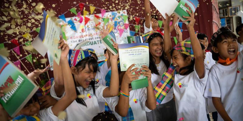 Group of children celebrating at a graduation event