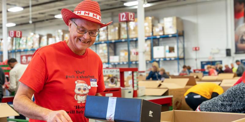 Grandpa excited to pack a shoebox