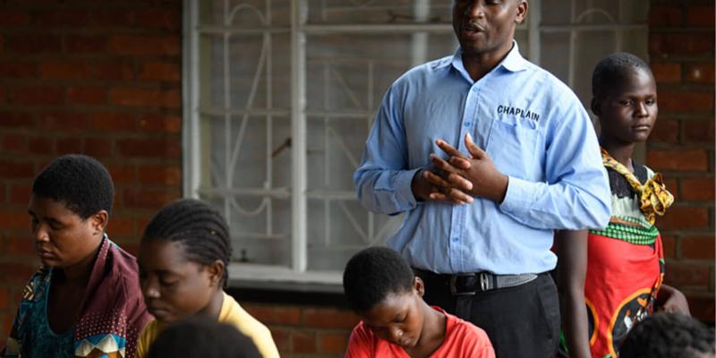 Frank prays over the staff and patients before the clinic opens at Nkhoma Hospital.