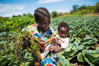 lady with baby in fields