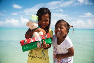 girls with shoebox gifts