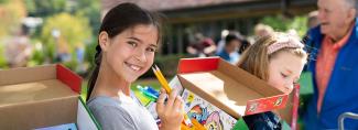 Girl packing a shoebox in the summer