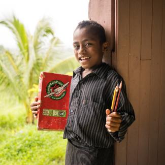 Boy holding pencils