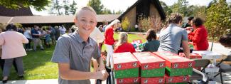 Boy with trolley of shoeboxes