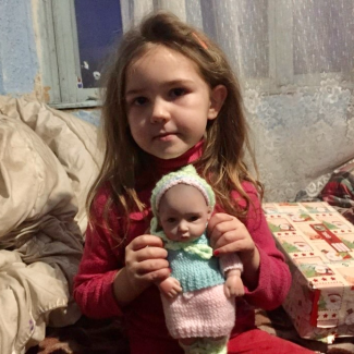 Ana holding her new doll