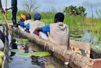 SOME OF OUR MOBILE MEDICAL TEAMS NAVIGATE FLOODED AREAS IN DUGOUT CANOES.