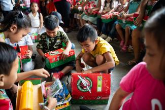 boy exploring shoebox gift