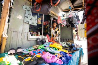 SAMRAWIT WORKING AT HER SHOP IN THE MARKET.