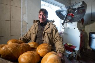 Sergey stands with a new batch of bread made from equipment provided by Samaritan’s Purse.