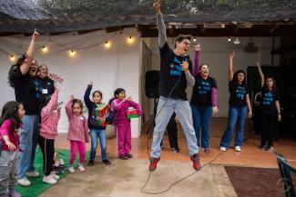 Pastor Roger jumps with joy as he and his team say “Amen”–pointing a finger in the air for the first half of the word and bringing it down to finish it.