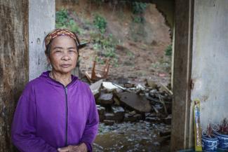 Tran stands in front of her crumbled home—one among the estimated 235,000 homes destroyed by Typhoon Yagi in Vietnam.