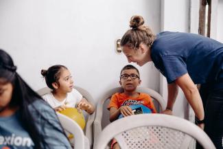 Madison Strausbaugh, the World Medical Mission speciality teams programme manager, brings joy to children waiting to receive dental care from our team.