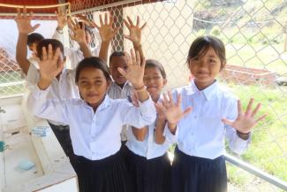 Students show off their clean fingers at their new handwashing station.