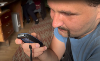 An anti-tank grenade launcher put Taras in a coma. When he awoke, he was unable to see. Pictured, Taras smiles as he listens to the words of the solar-powered audio Bible that he received from Samaritan’s Purse.