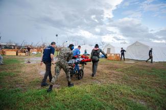 Team members rush a patient to the Samaritan’s Purse Emergency Field Hospital in Black River.