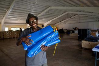 A Jamaican church leader collects tarps and other relief supplies from a Samaritan’s Purse distribution centre to deliver to his community.