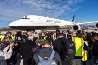 Liberty University students and leadership join Samaritan’s Purse leaders and the DC-8 flight crew in prayer, thanking God for the aircraft’s decade of life-saving missions.