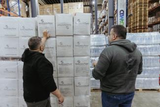 In a warehouse in Lebanon, team members tally boxes of jerry cans that arrived on the airlifts prior to distributing them to families in need.