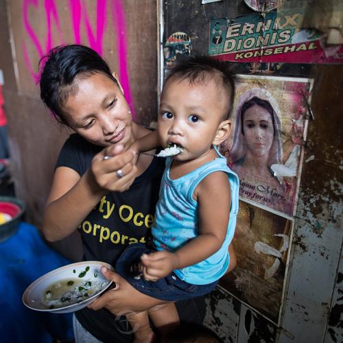 woman feeding child